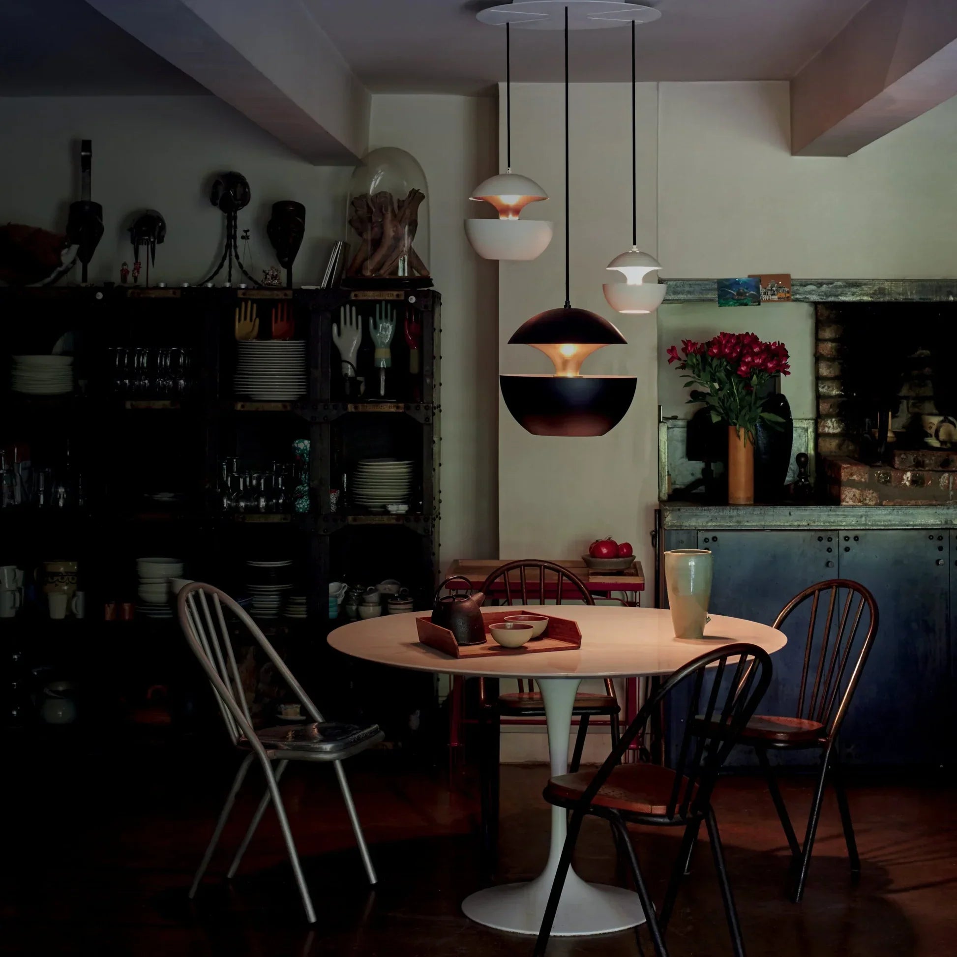 Dining area with a table and chairs in a dimly lit room.