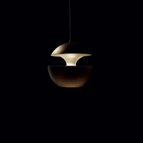 Modern pendant light with a metallic finish on a black background