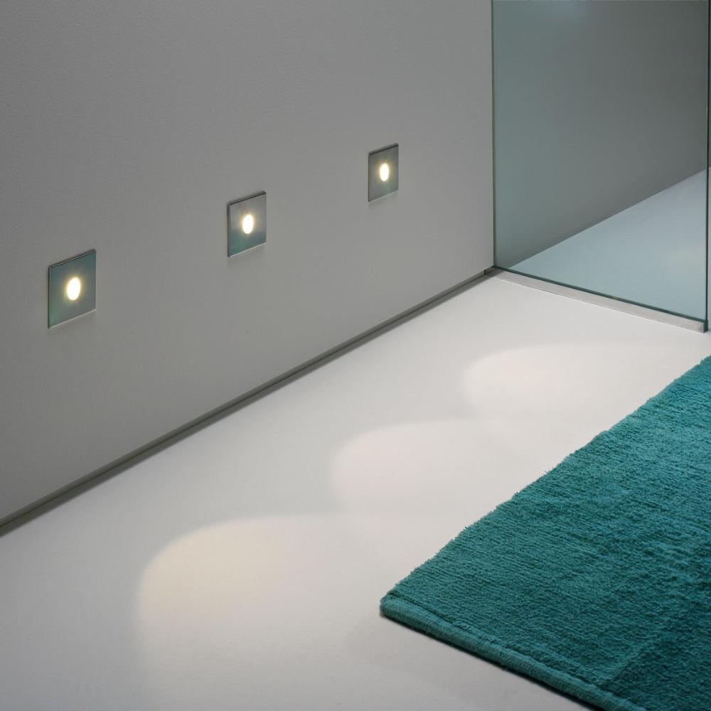Astro Tango step light in brushed steel in modern bathroom with teal rug