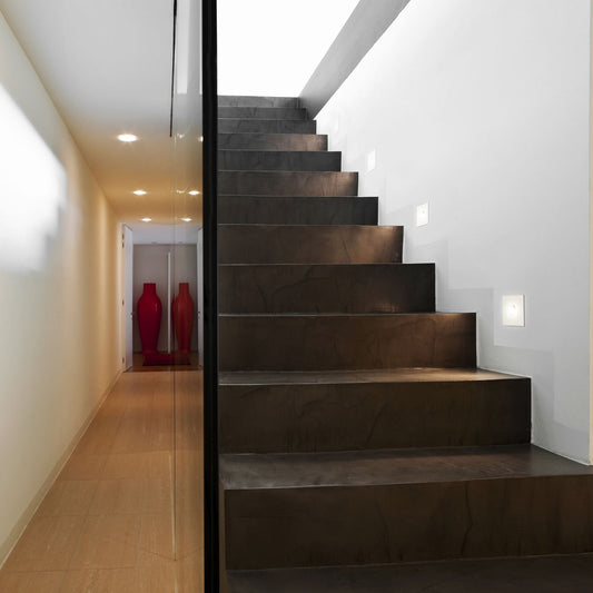 Astro Tango step light in white going up a modern stairway