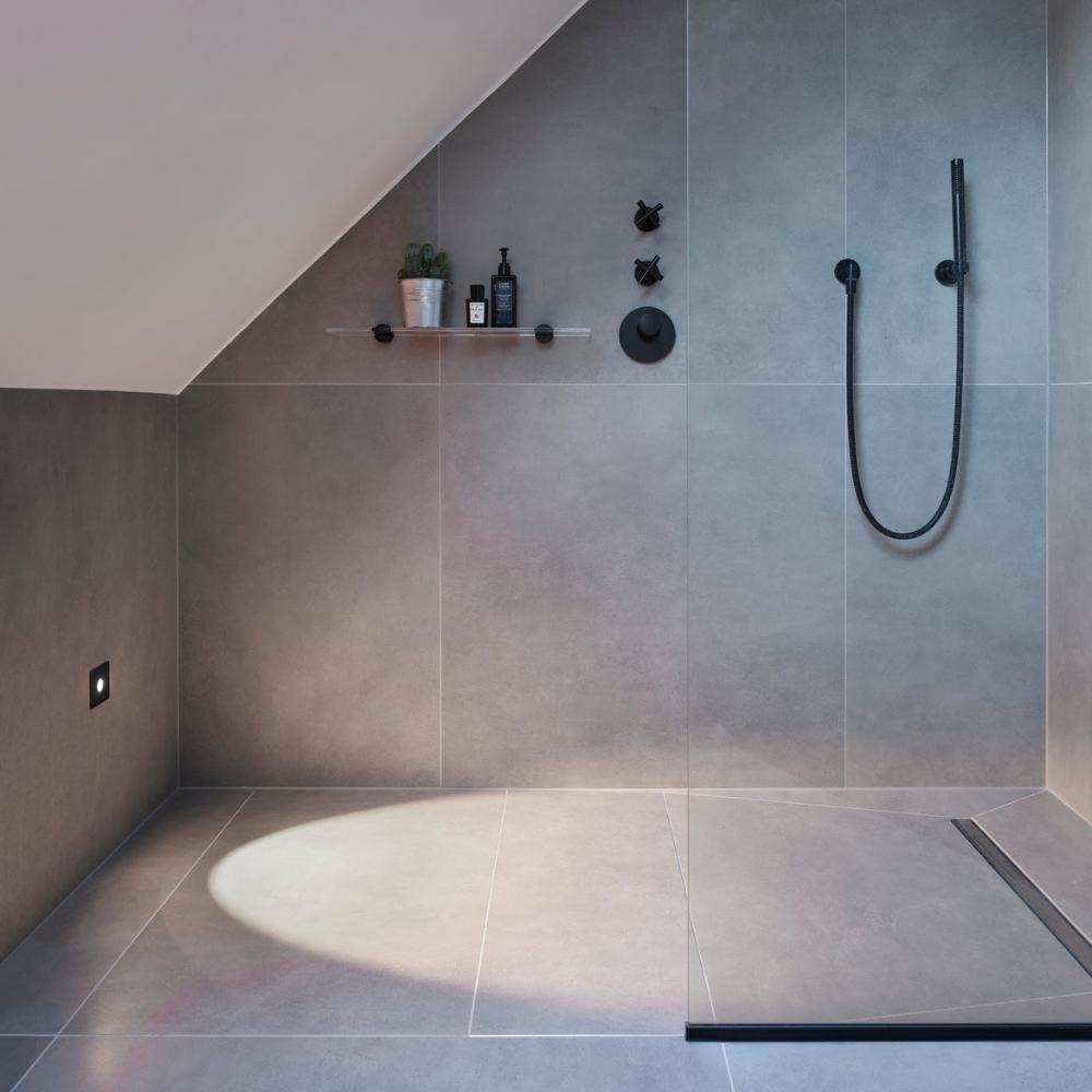 Astro Tango step light in black in modern minimal shower with a sloped ceiling