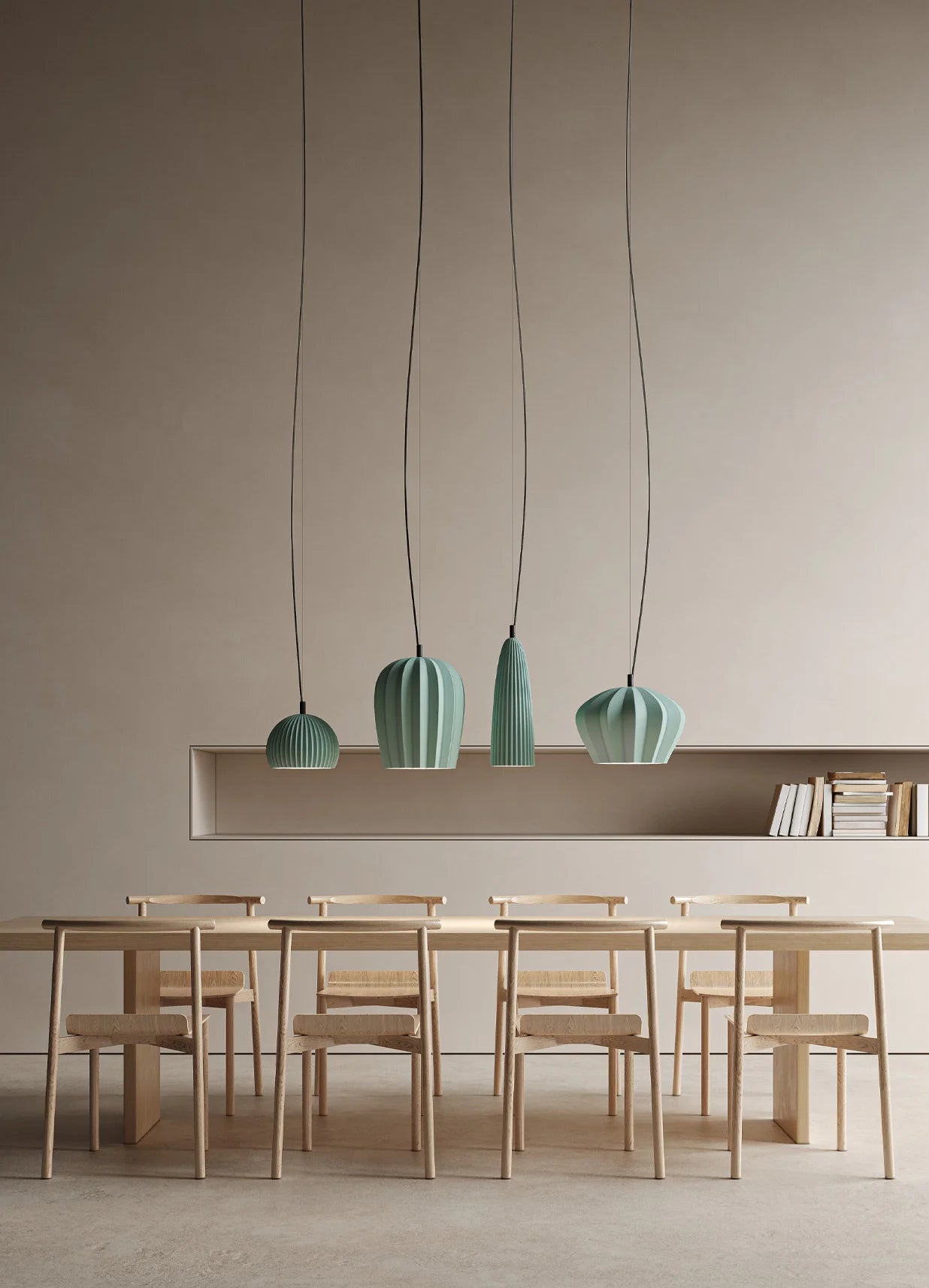 Modern interior with green pendant lights hanging above a dining table and chairs.